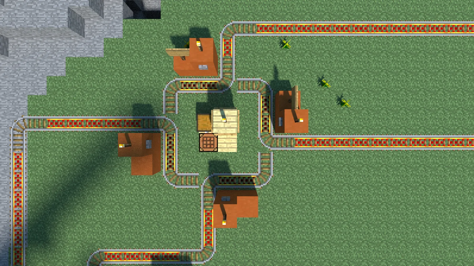 A minecart traffic-circle built in Minecraft: a looped rail where a cart circles indefinitely until the player reverses, the moment of reversal selecting which outbound line it takes.