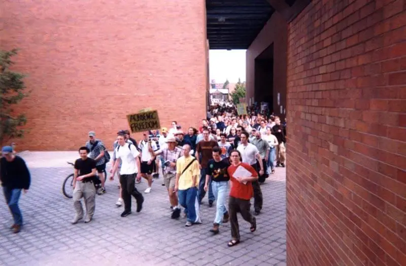 RIT students march on the administration building during the April, 1998 RCC rally, lead by Shea.